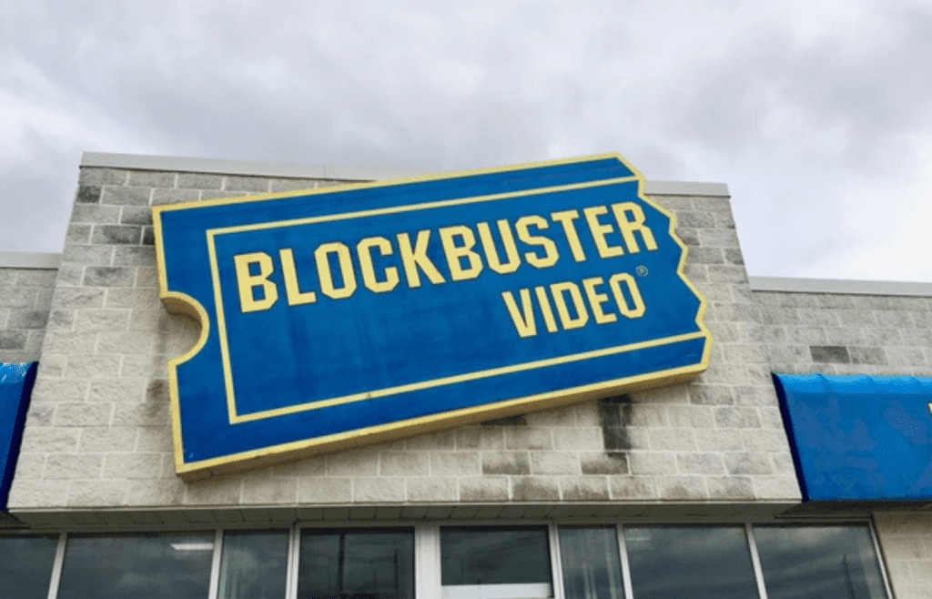 A faded blue-and-yellow video store sign