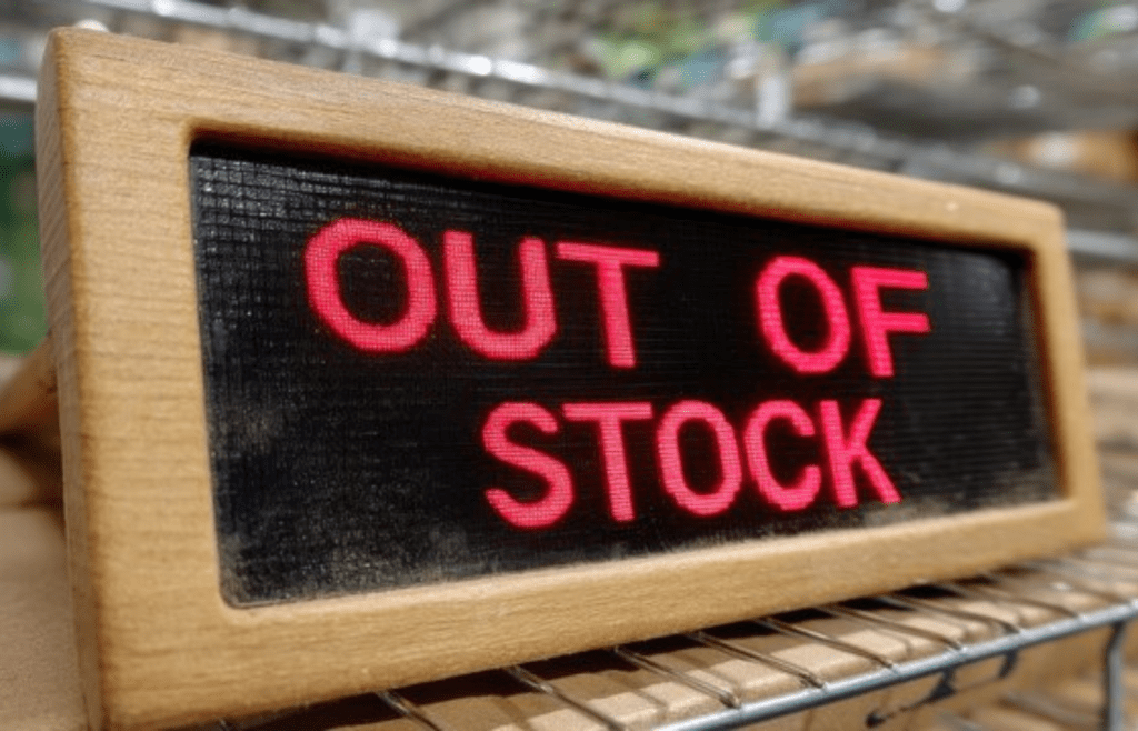 An empty electronics store with red signage