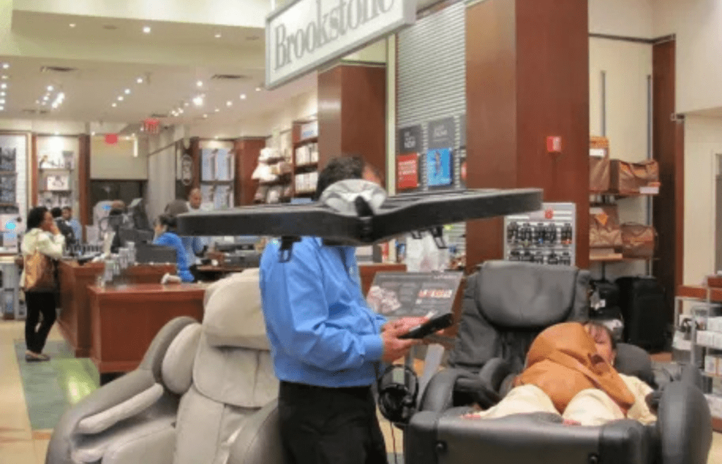 Gadgets and massage chairs in a sleek mall store