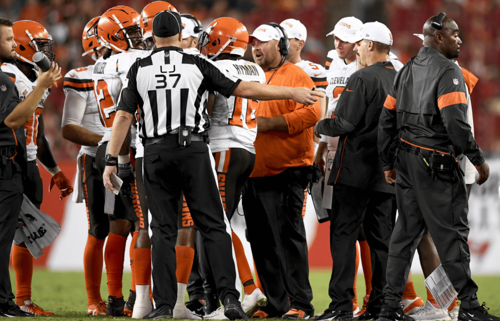 Aug 23, 2019; Tampa, FL, USA; Cleveland Browns head coach Freddie Kitchens (orange shirt) talks over a play with the team during the second half against the Tampa Bay Buccaneers at Raymond James Stadium. Mandatory Credit: Douglas DeFelice-Imagn Images