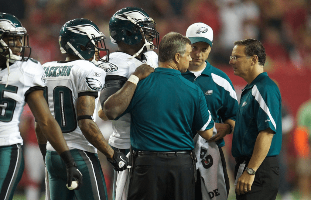 Philadelphia Eagles quarterback Michael Vick (middle) is checked on by a team trainer after being suffering a neck injury in the third quarter of a game against the Atlanta Falcons at the Georgia Dome.