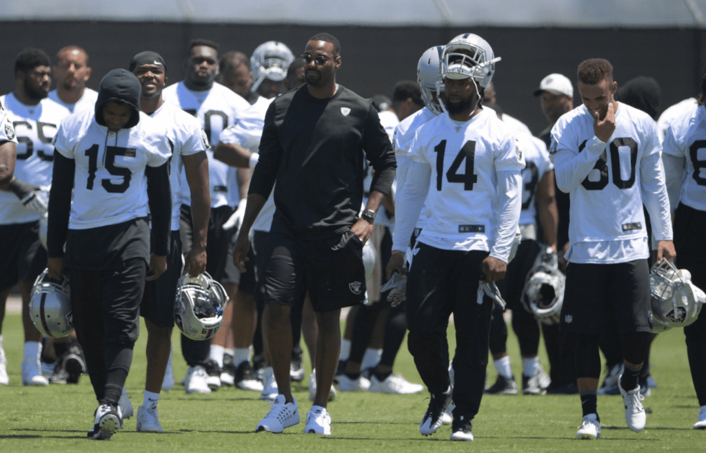 May 23, 2017; Alameda, CA, USA; Detroit Lions retired receiver Calvin Johnson (second from left) talks with Oakland Raiders receivers Michael Crabtree (15), Keon Hatcher (14) and K.J. Brent (80) during organized team activities at the Raiders practice facility. Mandatory Credit: Kirby Lee-Imagn Images