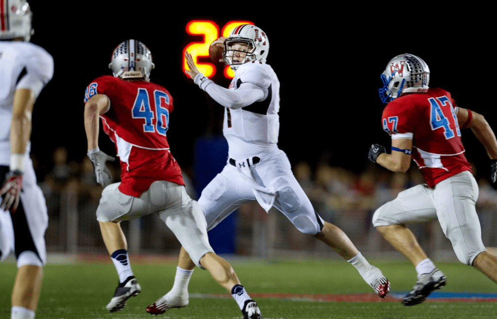 Lake Travis quarterback Baker Mayfield (11) looks for an opening to pass the ball in the game against Westlake on Friday night at Chaparral Stadium in Austin, Tx. This was the first time these teams played at 5A teams on Nov. 2, 2012.