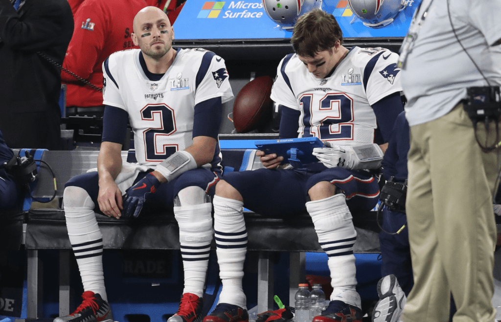 Feb 4, 2018; Minneapolis, MN, USA; New England Patriots quarterback Tom Brady (12) reviews plays on a tablet with Brian Hoyer (2) against the Philadelphia Eagles in Super Bowl LII at U.S. Bank Stadium. Mandatory Credit: Matthew Emmons-Imagn Images