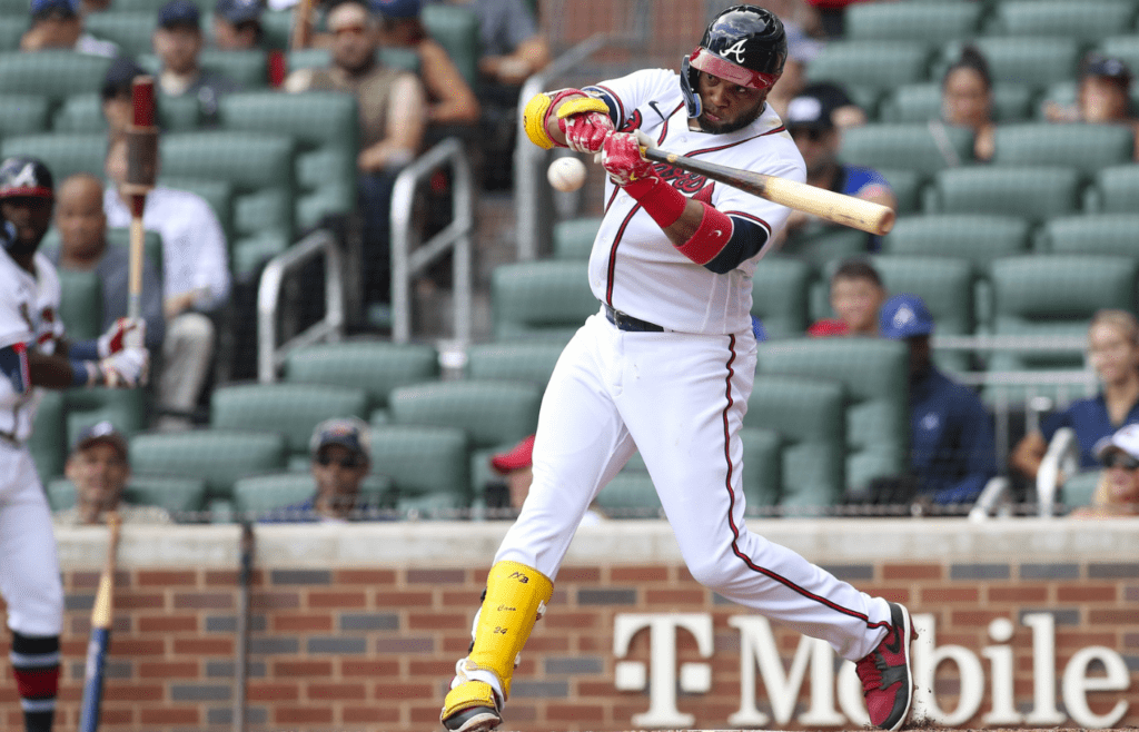 Jul 13, 2022; Atlanta, Georgia, USA; Atlanta Braves second baseman Robinson Cano (22) hits a single against the New York Mets in the seventh inning at Truist Park. Mandatory Credit: Brett Davis-Imagn Images