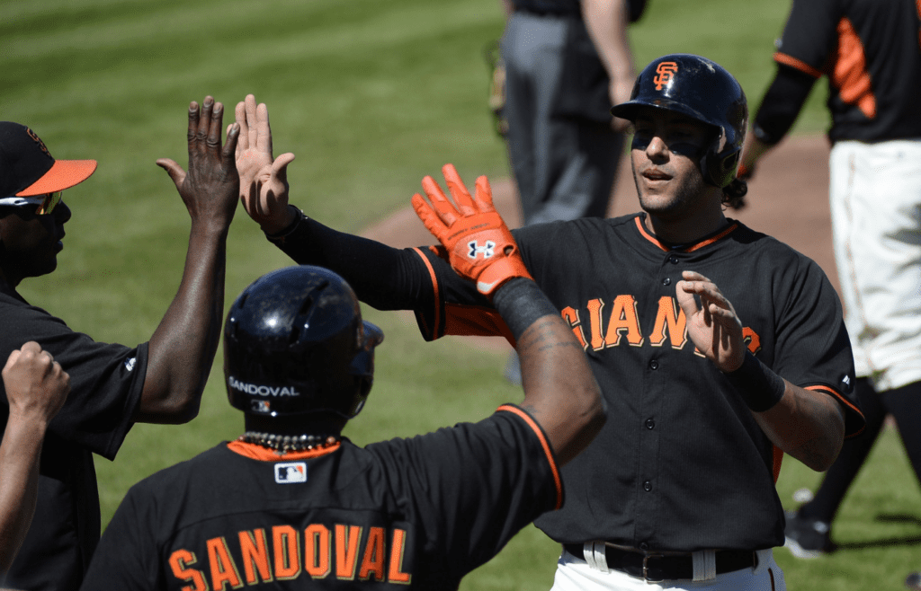 Mar 12, 2014; Scottsdale, AZ, USA; San Francisco Giants left fielder Mike Morse (38) is congratulated by teammates after scoring during the first inning against the Chicago White Sox at Scottsdale Stadium. Mandatory Credit: Christopher Hanewinckel-Imagn Images