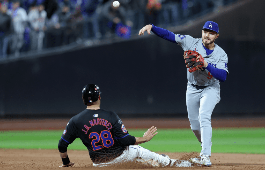 Oct 16, 2024; New York City, New York, USA; Los Angeles Dodgers second base Gavin Lux (9) gets a double play against New York Mets designated hitter J.D. Martinez (28) in the seventh inning during game three of the NLCS for the 2024 MLB playoffs at Citi Field. Mandatory Credit: Brad Penner-Imagn Images
