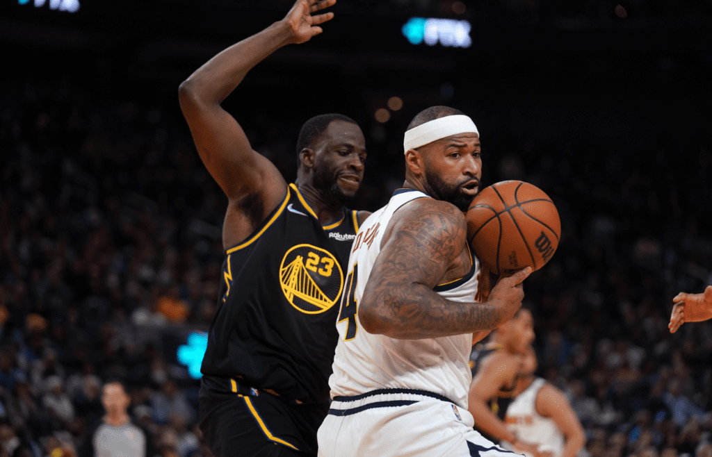 Apr 27, 2022; San Francisco, California, USA; Denver Nuggets center DeMarcus Cousins (4) spins away from Golden State Warriors forward Draymond Green (23) in the fourth quarter during game five of the first round for the 2022 NBA playoffs at Chase Center. Mandatory Credit: Cary Edmondson-Imagn Images