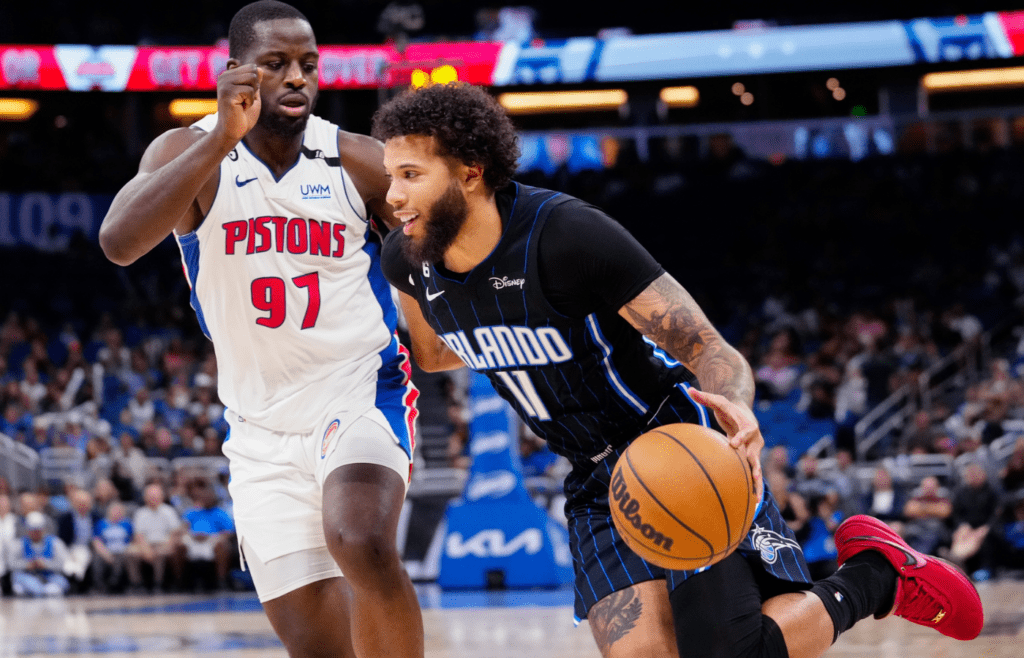 Apr 2, 2023; Orlando, Florida, USA; Orlando Magic guard Michael Carter-Williams (11) dribbles the ball past Detroit Pistons forward Eugene Omoruyi (97) during the second half at Amway Center. Mandatory Credit: Rich Storry-Imagn Images