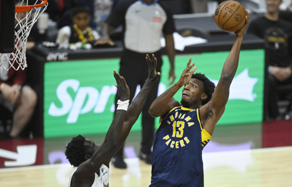 Oct 10, 2024; Cleveland, Ohio, USA; Indiana Pacers center James Wiseman (13) shoots beside Cleveland Cavaliers forward JT Thor (15) in the fourth quarter at Rocket Mortgage FieldHouse. Mandatory Credit: David Richard-Imagn Images