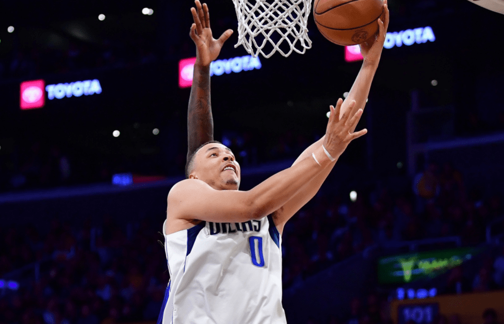 Feb 25, 2025; Los Angeles, California, USA; Dallas Mavericks guard Dante Exum (0) shoots the ball against the Los Angeles Lakers during the first half at Crypto.com Arena. Mandatory Credit: Gary A. Vasquez-Imagn Images
