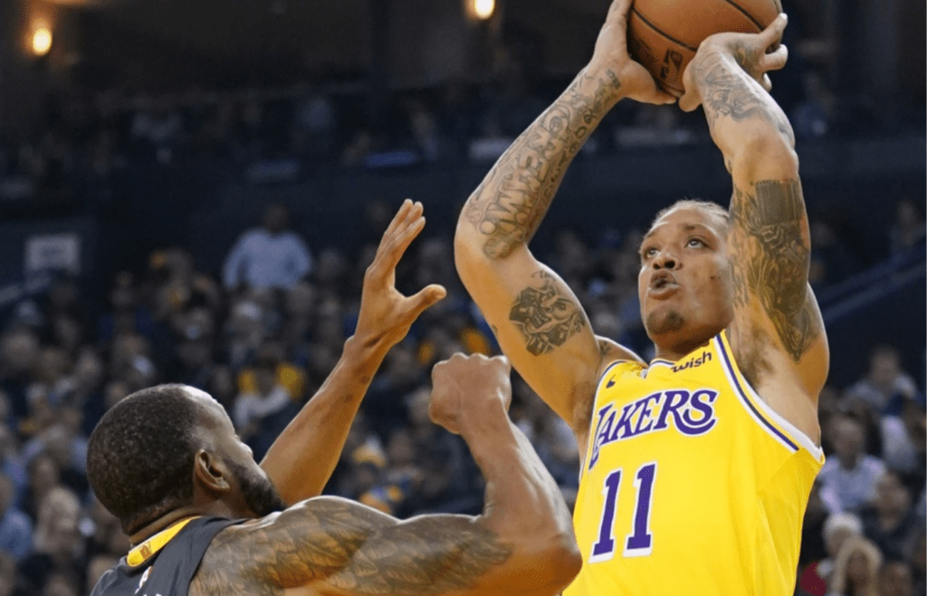 February 2, 2019; Oakland, CA, USA; Los Angeles Lakers forward Michael Beasley (11) shoots the basketball against Golden State Warriors forward Andre Iguodala (9) during the second quarter at Oracle Arena. Mandatory Credit: Kyle Terada-Imagn Images
