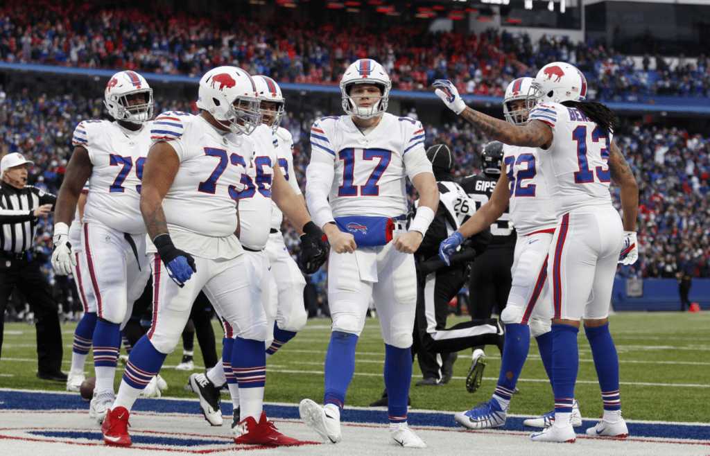 Nov 25, 2018; Orchard Park, NY, USA; Buffalo Bills quarterback Josh Allen (17) celebrates his touchdown with offensive tackle Dion Dawkins (73) and wide receiver Kelvin Benjamin (13) during the second half against the Jacksonville Jaguars at New Era Field. Mandatory Credit: Timothy T. Ludwig-Imagn Images