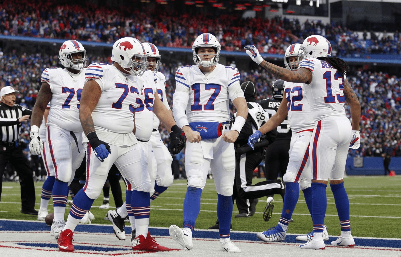 Buffalo Bills quarterback Josh Allen (17) celebrates his touchdown with offensive tackle Dion Dawkins (73) and wide receiver Kelvin Benjamin (13) during the second half against the Jacksonville Jaguars at New Era Field.