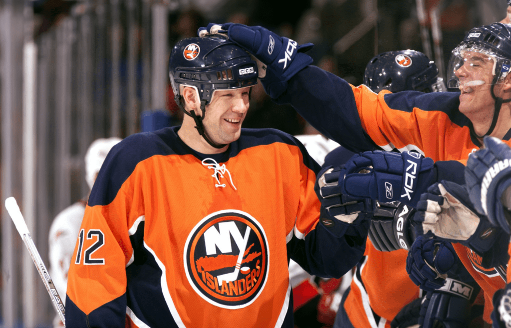 Oct 21, 2006; Uniondale, NY, USA; New York Islanders left wing Chris Simon (12) celebrates with teammates against the Carolina Hurricanes at Nassau Veterans Memorial Coliseum. Credit: Lou Capozzola-USA TODAY NETWORK