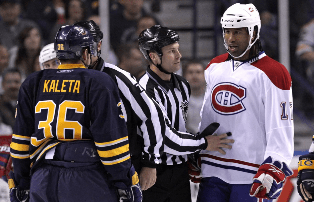 Oct 3, 2009; Buffalo, NY, USA; Montreal Canadiens right wing Georges Laraque (17) and Buffalo Sabres right wing Patrick Kaleta (36) have words in the first period at HSBC Arena. Mandatory Credit: Kevin Hoffman-Imagn Images