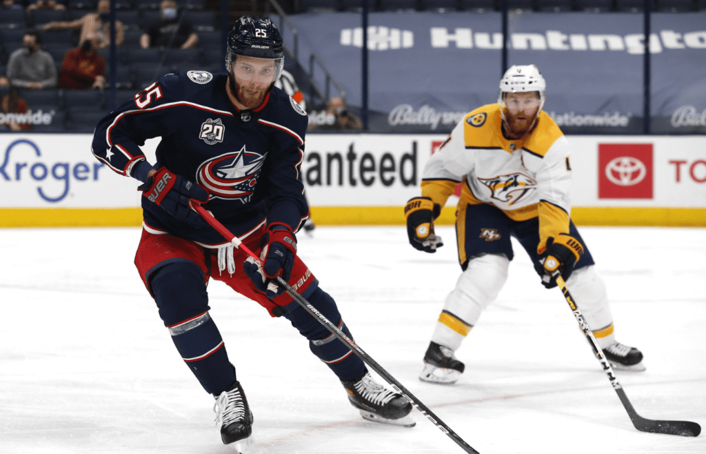 Columbus Blue Jackets center Mikhail Grigorenko (25) skates with the puck as Nashville Predators defenseman Ryan Ellis (4) defends during the first period at Nationwide Arena.