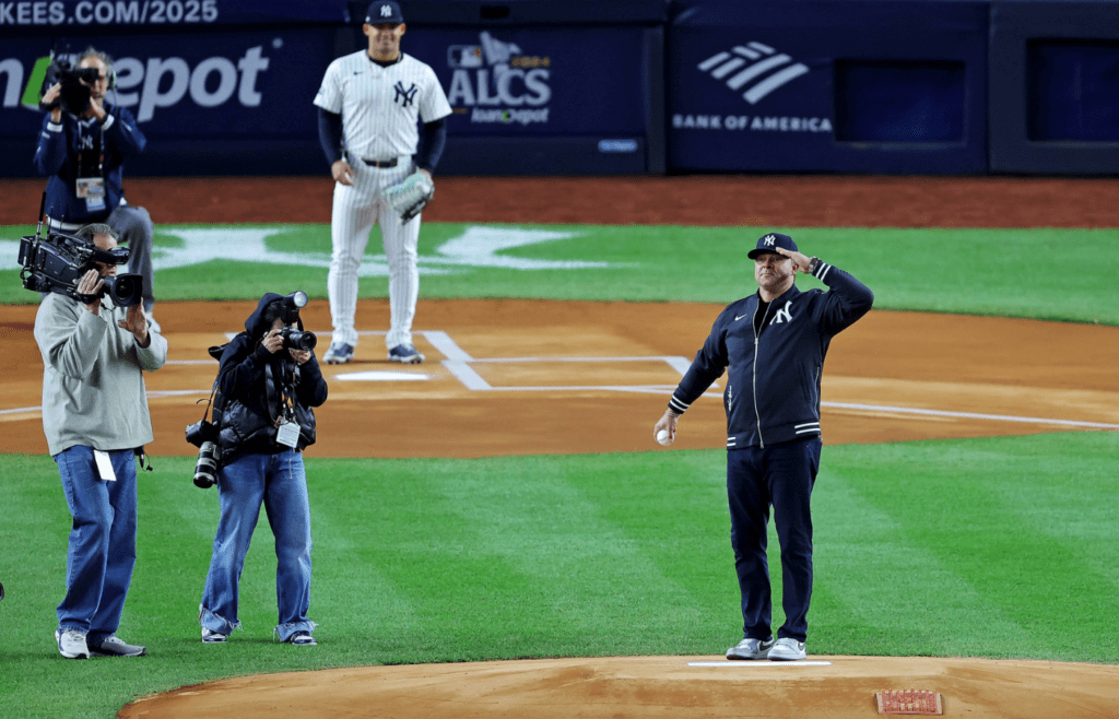 New York Yankees former player Nick Swisher salutes the crowd before throwing the ceremonial first pitch before game two of the ALCS for the 2024 MLB Playoffs between the New York Yankees and the Cleveland Guardians at Yankee Stadium.