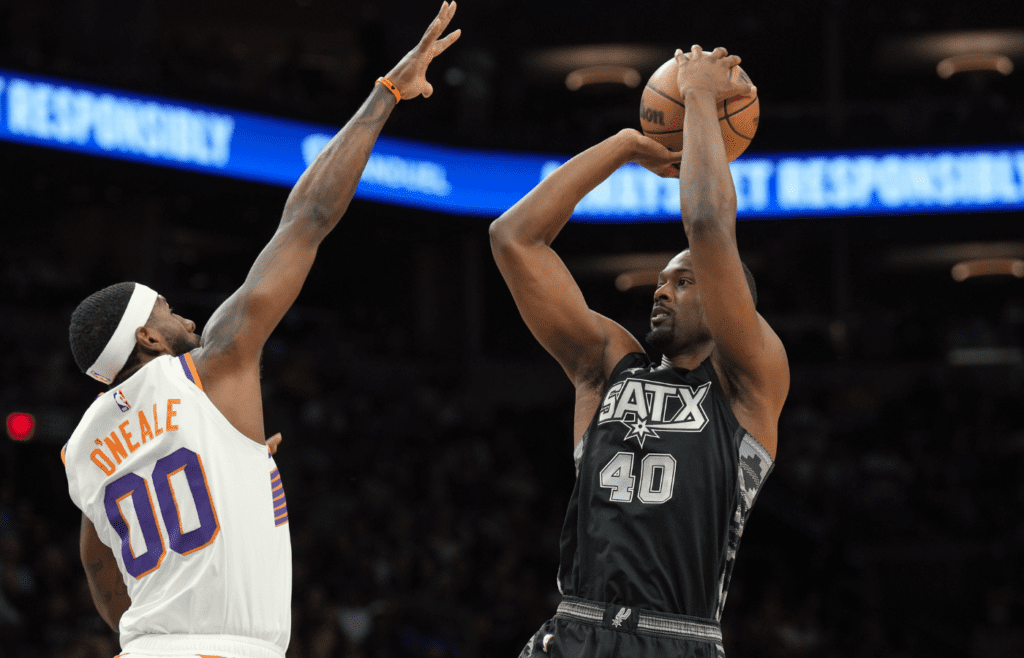 Apr 11, 2025; Phoenix, Arizona, USA; San Antonio Spurs forward Harrison Barnes (40) shoots over Phoenix Suns forward Royce O'Neale (00) during the first half at Footprint Center. Mandatory Credit: Joe Camporeale-Imagn Images
