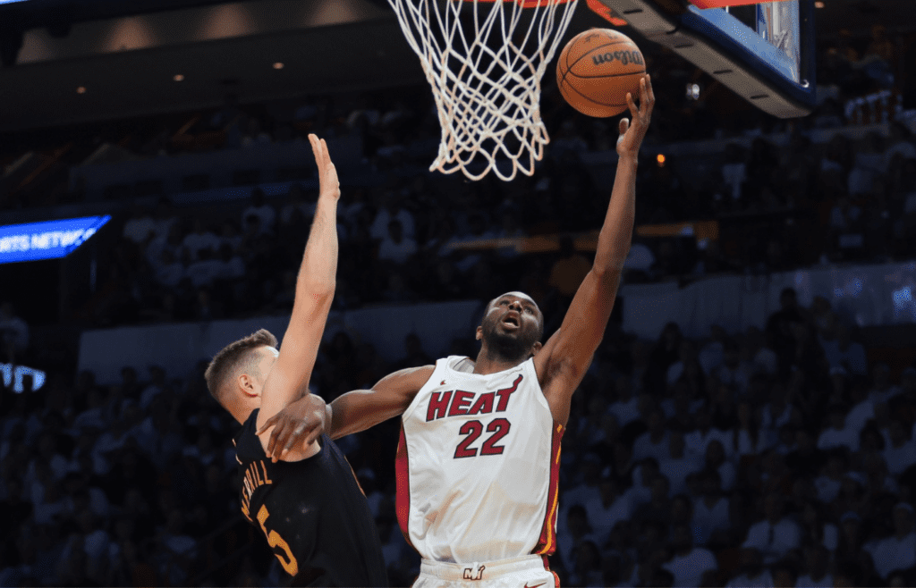 Apr 26, 2025; Miami, Florida, USA;Miami Heat forward Andrew Wiggins (22) drives to the basket against Cleveland Cavaliers guard Sam Merrill (5) in the third quarter during game three for the first round of the 2025 NBA Playoffs at Kaseya Center. Mandatory Credit: Sam Navarro-Imagn Images