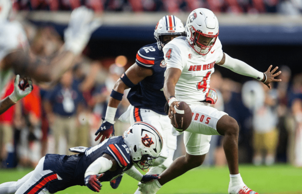 New Mexico Lobos quarterback Devon Dampier (4) avoids a tackle from Auburn Tigers linebacker Demarcus Riddick (16) as Auburn Tigers take on New Mexico Lobos at Jordan-Hare Stadium in Auburn, Ala., on Saturday, Sept. 14, 2024.