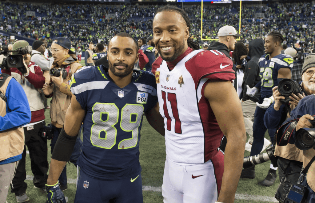 Dec 30, 2018; Seattle, WA, USA; Seattle Seahawks wide receiver Doug Baldwin (89) and Arizona Cardinals wide receiver Larry Fitzgerald (11) pose for a photo after the game at CenturyLink Field. Seattle defeated Arizona 27-24. Mandatory Credit: Steven Bisig-Imagn Images