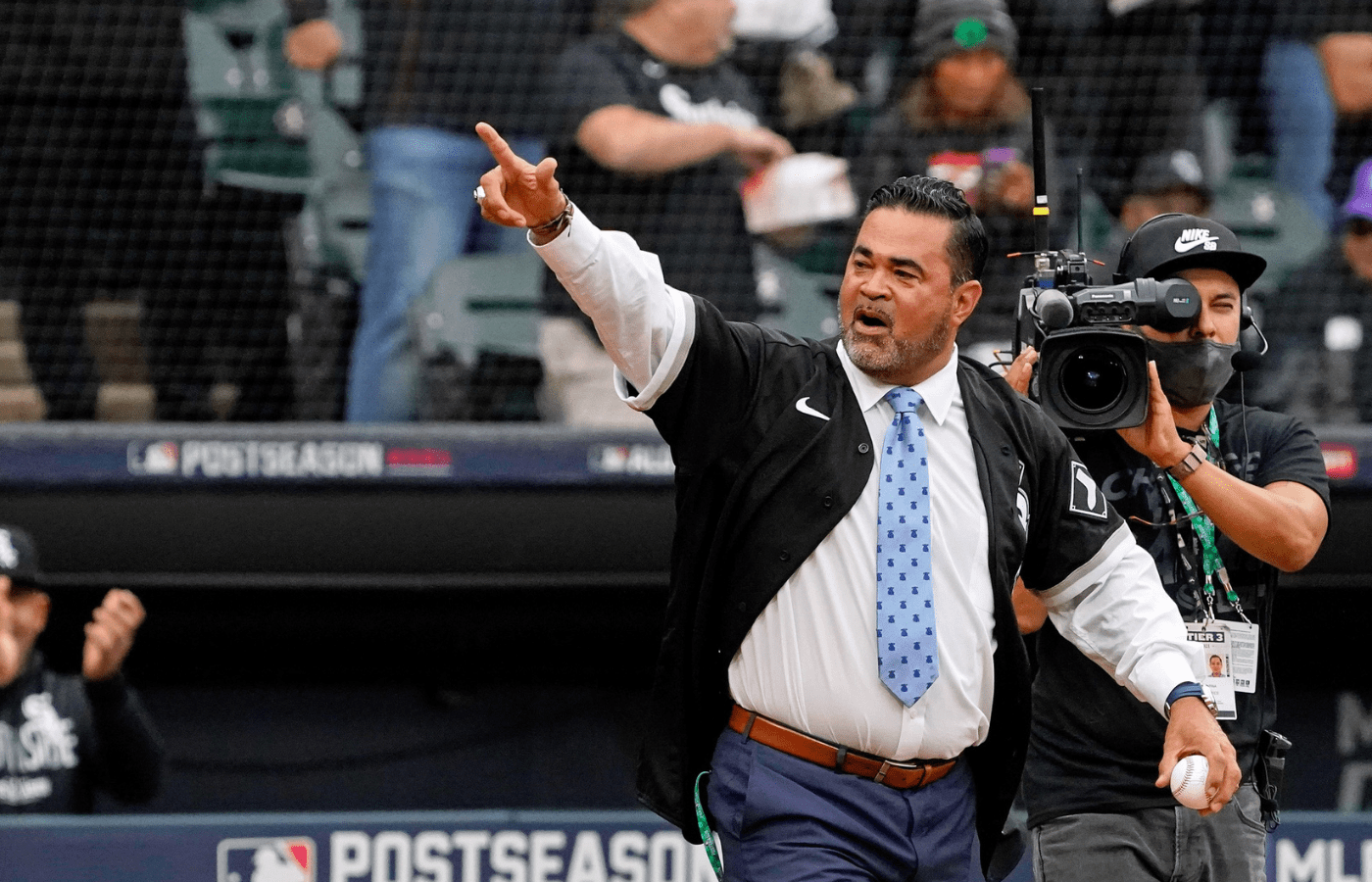 Oct 12, 2021; Chicago, Illinois, USA; Former Chicago White Sox player and manager Ozzie Guillen acknowledges the crowd as he walks onto the field before throwing a ceremonial first pitch before game four of the 2021 ALDS between the Chicago White Sox and the Houston Astros at Guaranteed Rate Field. Mandatory Credit: David Banks-Imagn Images