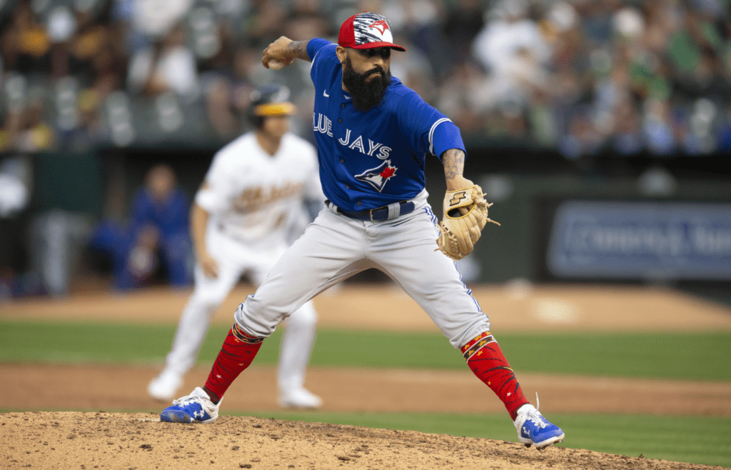 Jul 4, 2022; Oakland, California, USA; Toronto Blue Jays pitcher Sergio Romo (54) delivers a pitch against the Oakland Athletics in the sixth inning at RingCentral Coliseum. Mandatory Credit: D. Ross Cameron-Imagn Images