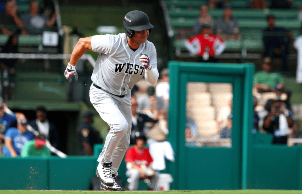 Jun 19, 2025; Birmingham, AL, USA; West team outfielder Nick Swisher (33) sprints to first base during the East-West Classic at Rickwood Field. Mandatory Credit: David Leong-Imagn Images