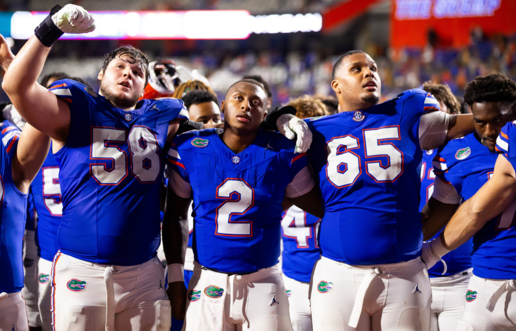 Florida Gators offensive lineman Austin Barber (58),Florida Gators quarterback DJ Lagway (2) and Florida Gators offensive lineman Brandon Crenshaw-Dickson (65) all sing at the end of the game at Ben Hill Griffin Stadium in Gainesville, FL on Saturday, October 5, 2024. [Doug Engle/Gainesville Sun]