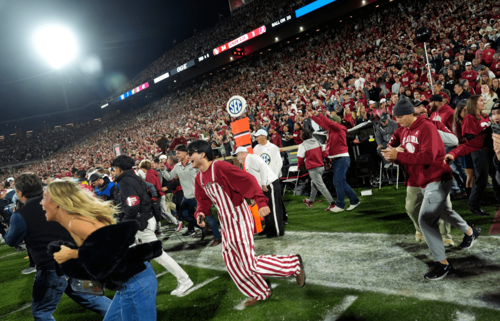 Fans rush the field after a college football game between the University of Oklahoma Sooners (OU) and the Alabama Crimson Tide at Gaylord Family - Oklahoma Memorial Stadium in Norman, Okla., Saturday, Nov. 23, 2024. Oklahoma won 24-3.