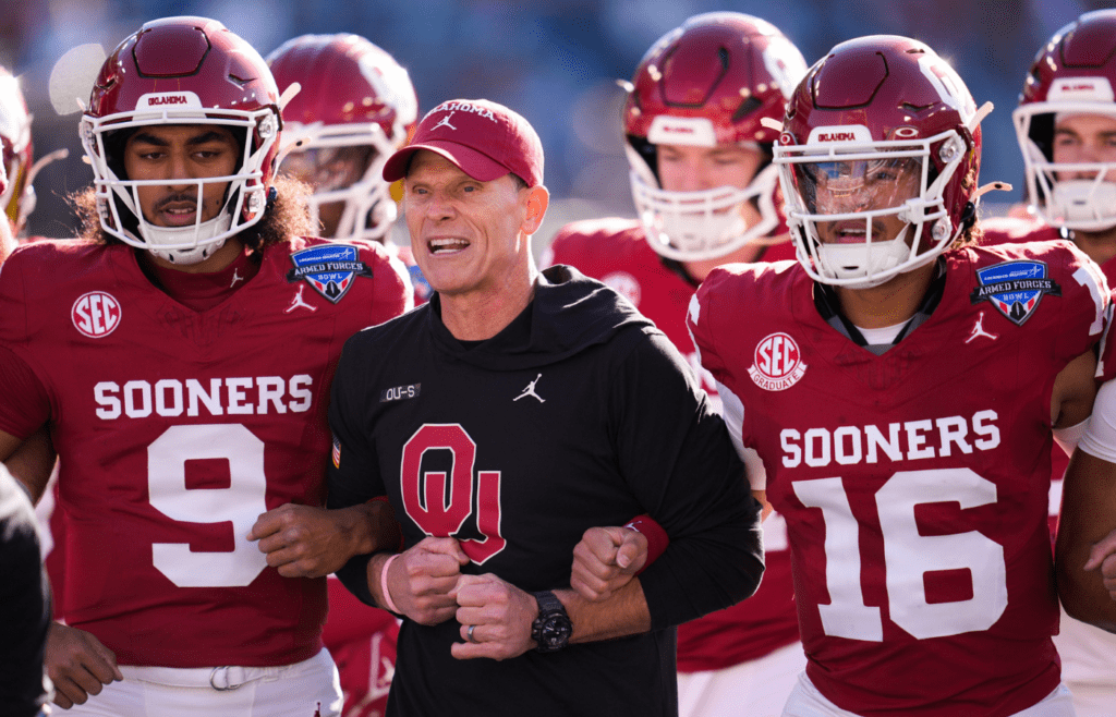 Oklahoma coach Brent Venables locks arms with players before the Armed Forces Bowl football game between the University of Oklahoma Sooners (OU) and the Navy Midshipmen at Amon G. Carter Stadium in Fort Worth, Texas, Friday, Dec. 27, 2024. Navy won 21-20