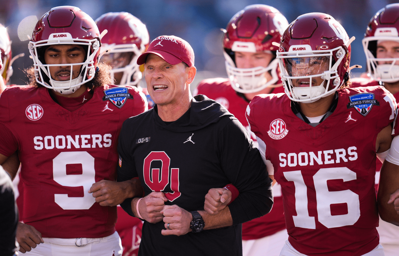 Oklahoma coach Brent Venables locks arms with players before the Armed Forces Bowl football game between the University of Oklahoma Sooners (OU) and the Navy Midshipmen at Amon G. Carter Stadium in Fort Worth, Texas, Friday, Dec. 27, 2024. Navy won 21-20