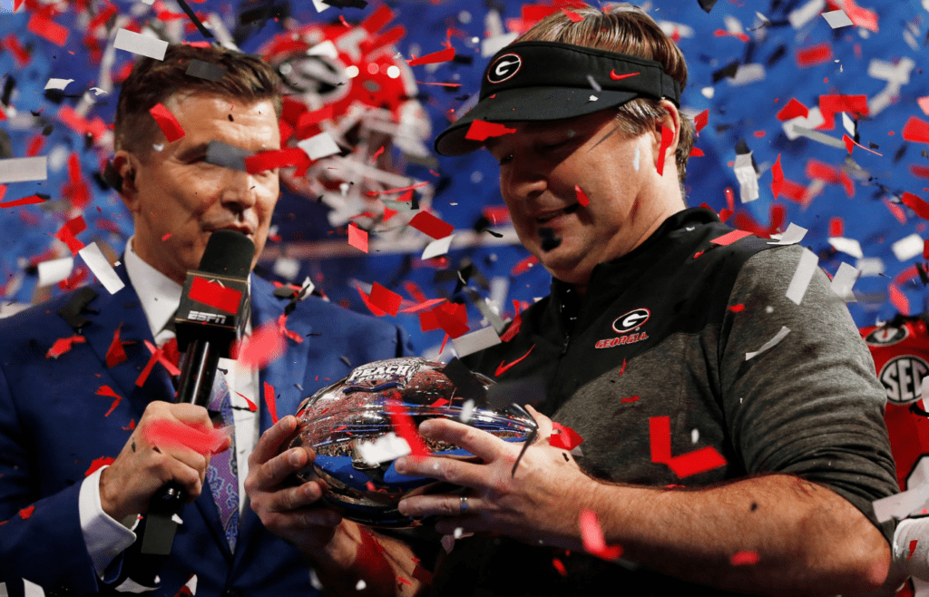Georgia coach Kirby Smart is presented with the Chick-fil-A Peach Bowl trophy after winning the Chick-fil-A Peach Bowl NCAA College Football Playoff semifinal game between Ohio State and Georgia on Sunday, Jan 1, 2022, in Atlanta. Georgia won 42-41. News Joshua L Jones