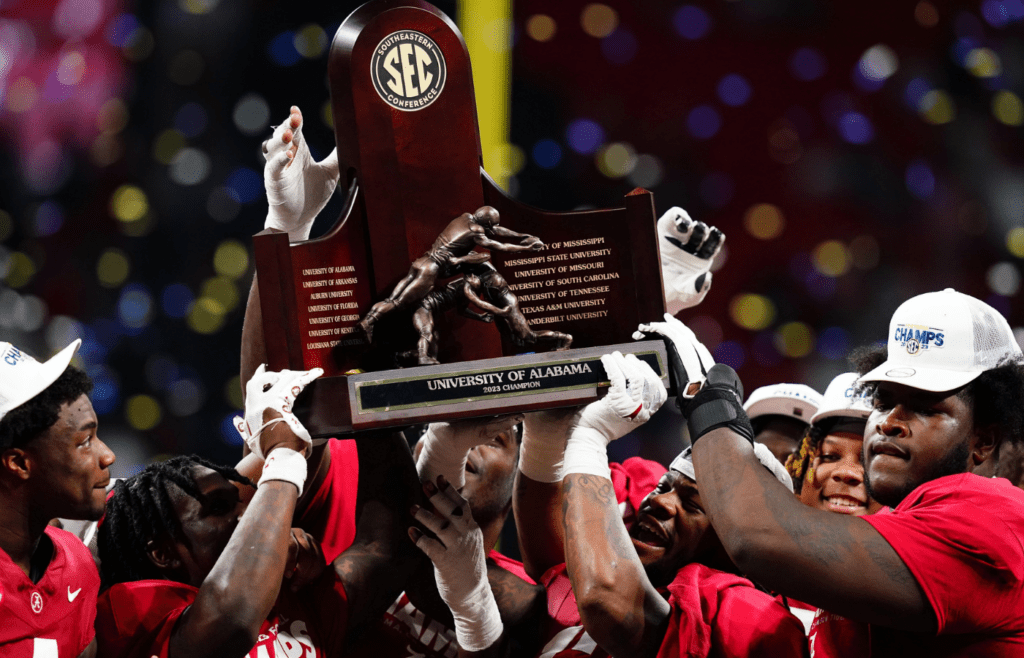 Dec 2, 2023; Atlanta, GA, USA; The Alabama Crimson Tide celebrate with the SEC championship trophy after defeating the Georgia Bulldogs at Mercedes-Benz Stadium. Mandatory Credit: John David Mercer-Imagn Images