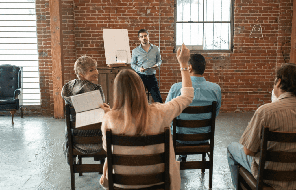 A person raising their hand in a discussion