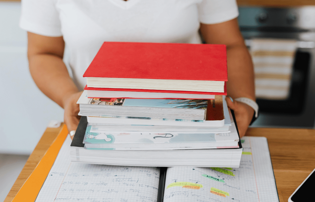 A stack of school textbooks with branded covers