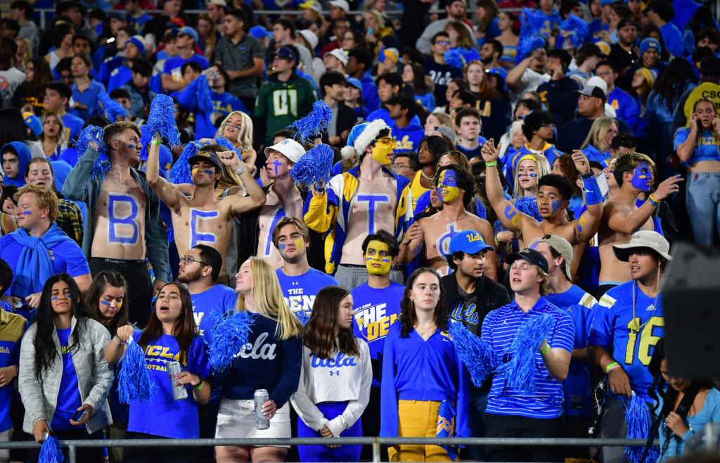 Nov 19, 2022; Pasadena, California, USA; UCLA Bruins student fan section cheers against the Southern California Trojans during the first half at the Rose Bowl. Mandatory Credit: Gary A. Vasquez-Imagn Images