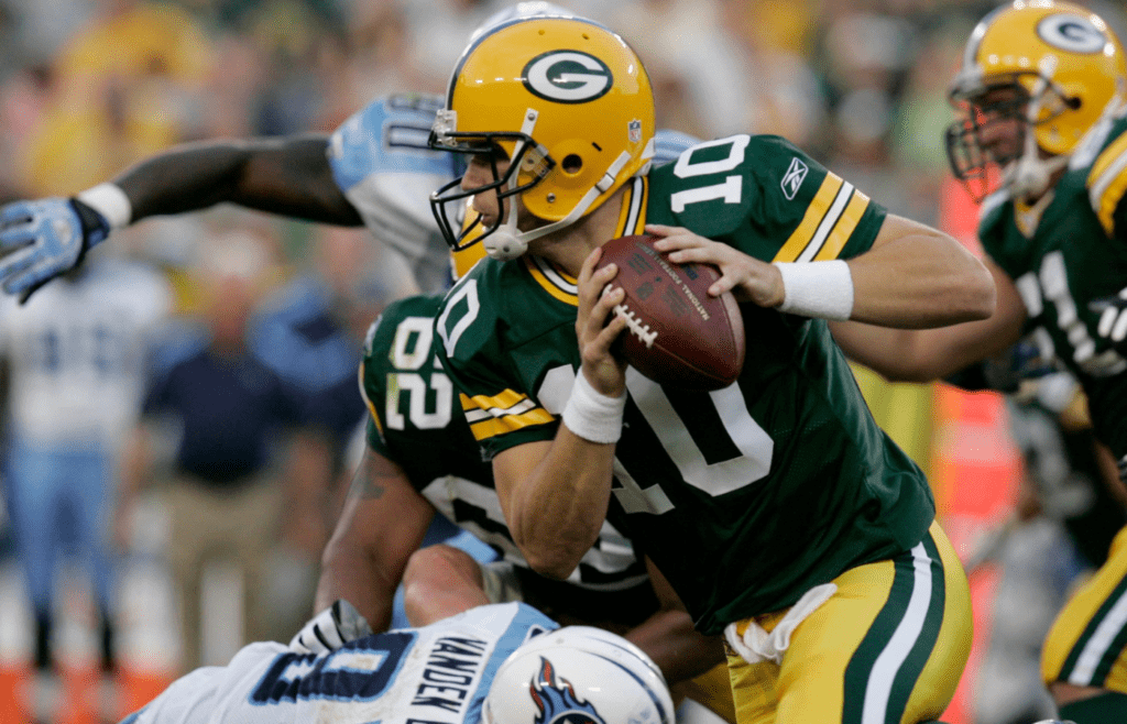 Green Bay Packers rookie quarterback Matt Flynn scrmables for yardage while evading a Tennessee Titans tackle during the second quarter of their game Thursday, August 28, 2008 at Lambeau Field in Green Bay, Wis.