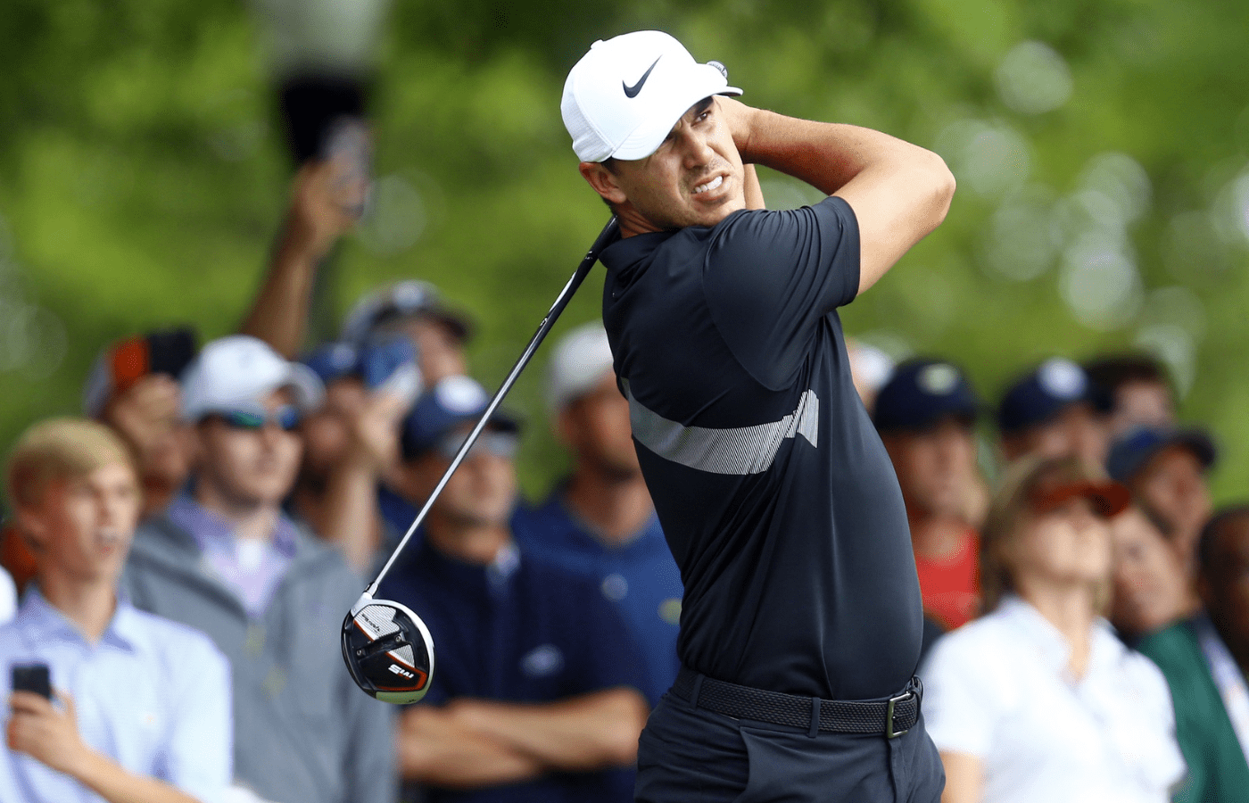 Brooks Koepka plays his shot from the tenth tee during the final round of the Tour Championship golf tournament at East Lake Golf Club.