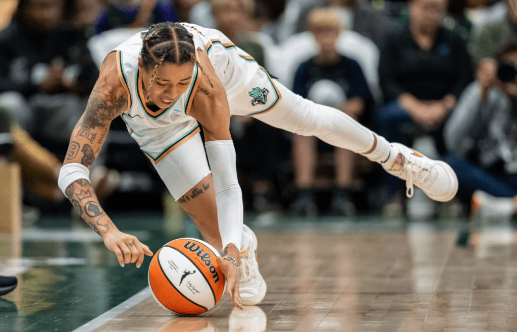 New York Liberty guard Natasha Cloud (9) dives for a loose ball during the second half against the Seattle Storm at Climate Pledge Arena.