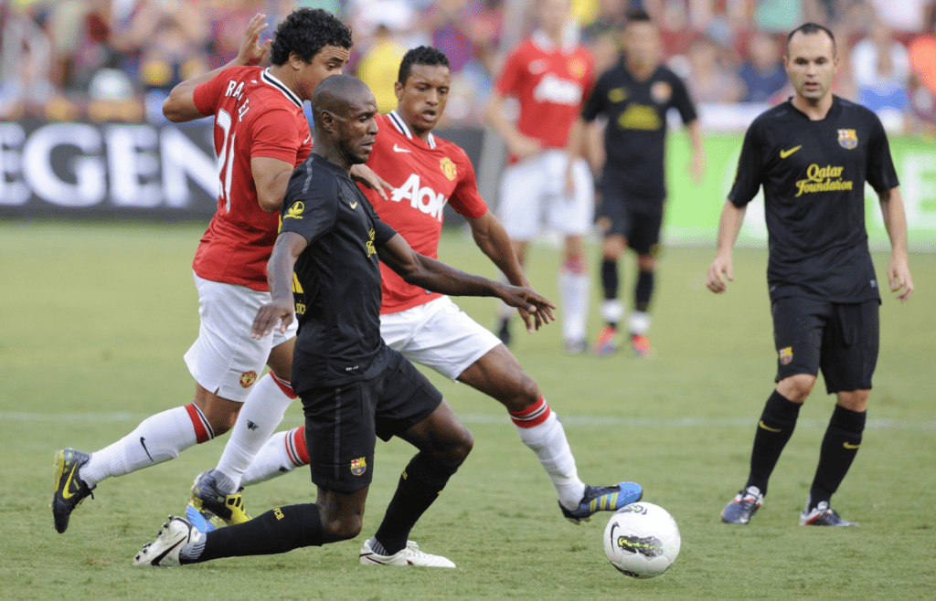 Barcelona defender Eric Abidal (22) battles Manchester United defender Rafael da Silva (21) for a loose ball during the first half of the Herbalife World Football Challenge 2011 at FedEx Field.