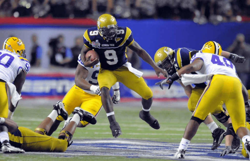 Dec 31, 2008; Atlanta, GA, USA; Georgia Tech Yellow Jackets quarterback Josh Nesbitt (9) runs through the LSU Tigers defensive line in the first half at the Chick-fil-A Bowl at the Georgia Dome. Mandatory Credit: Dale Zanine-Imagn Images