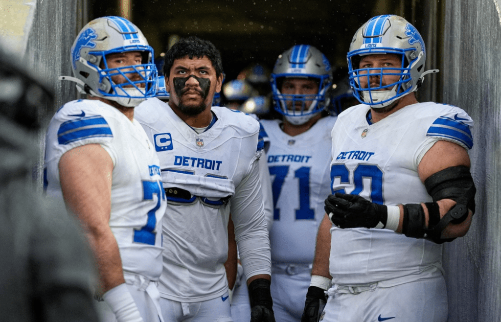 From left, Detroit Lions center Frank Ragnow (77), offensive tackle Penei Sewell (58), guard Kevin Zeitler (71), and guard Graham Glasgow (60) look on from the listing team tunnel before taking the field for first half against Green Bay Packers at Lambeau Field in Green Bay, Wis. on Sunday, Nov. 3, 2024.