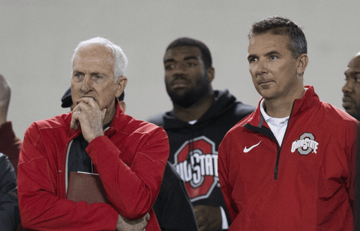 Mar 7, 2014; Columbus, OH, USA; Ohio State Buckeyes head coach Urban Meyer (r) and former head coach and current Cincinnati Bengals scouting consultant John Cooper watch as players work out in front of NFL scouts on pro day at The Woody Hayes Athletic Center. Mandatory Credit: Greg Bartram-Imagn Images
