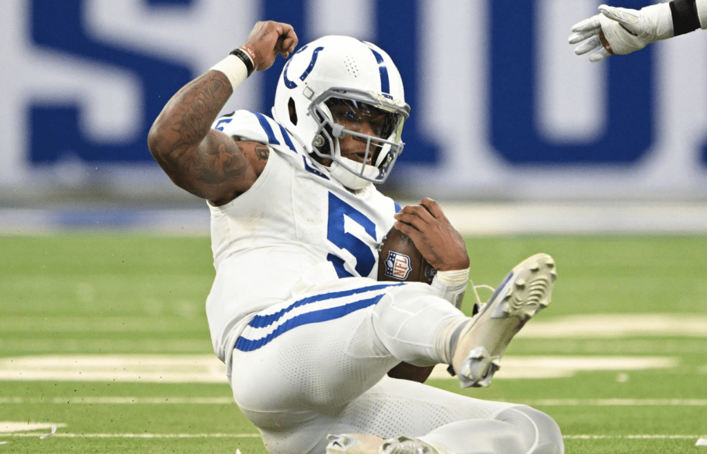 Dec 22, 2024; Indianapolis, Indiana, USA; Indianapolis Colts quarterback Anthony Richardson (5) slides in front of Tennessee Titans cornerback Jarvis Brownlee Jr. (29) during the second half at Lucas Oil Stadium. Mandatory Credit: Marc Lebryk-Imagn Images