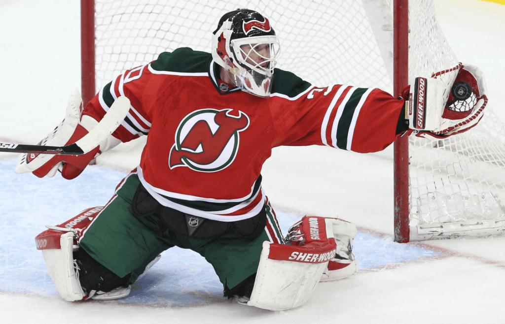 Mar 17; Newark, NJ, USA; New Jersey Devils goalie Martin Brodeur (30) makes a save during the third period of their game against the Pittsburgh Penguins at the Prudential Center. The Penguins defeated the Devils 5-2. Mandatory Credit: Ed Mulholland-Imagn Images