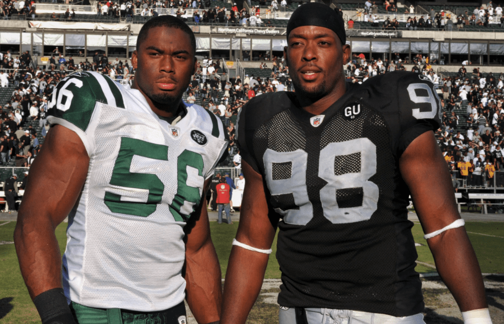 Oct 19, 2008; Oakland, CA, USA; Ohio State Buckeyes former teammates Vernon Gholston of the New York Jets (56) and Jay Richardson of the Oakland Raiders (98) pose after the game at the Oakland Coliseum. Mandatory Credit: Kirby Lee/Image of Sport-Imagn Images