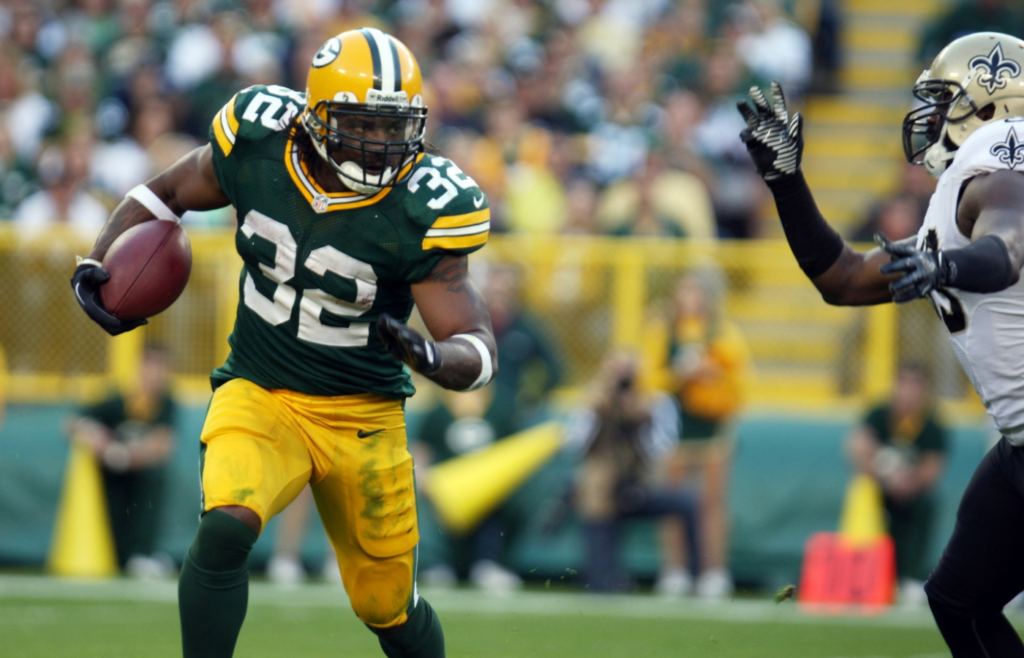 Sept. 30, 2012; Green Bay, WI, USA; Green Bay Packers running back Cedric Benson (32) looks for air against a New Orleans Saints defender at Lambeau Field. The Green Bay Packers defeated the New Orleans Saints 28-27. Mandatory Credit: Mary Langenfeld-Imagn Images