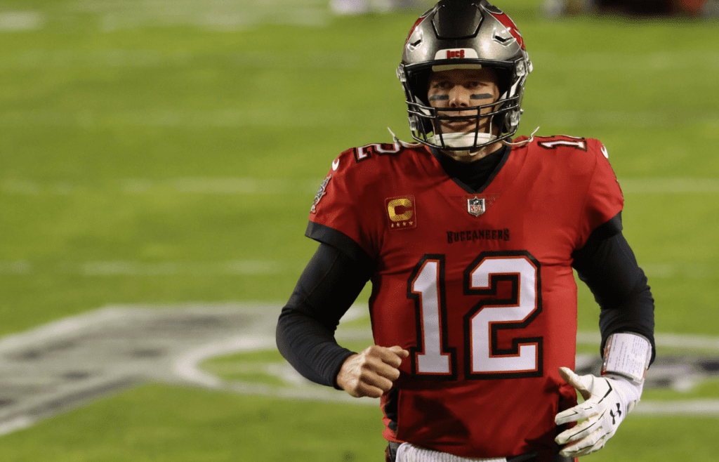 Jan 9, 2021; Landover, Maryland, USA; Tampa Bay Buccaneers quarterback Tom Brady (12) runs onto the field for warmups prior to the Buccaneers' game against the Washington Football Team at FedExField. Mandatory Credit: Geoff Burke-Imagn Images